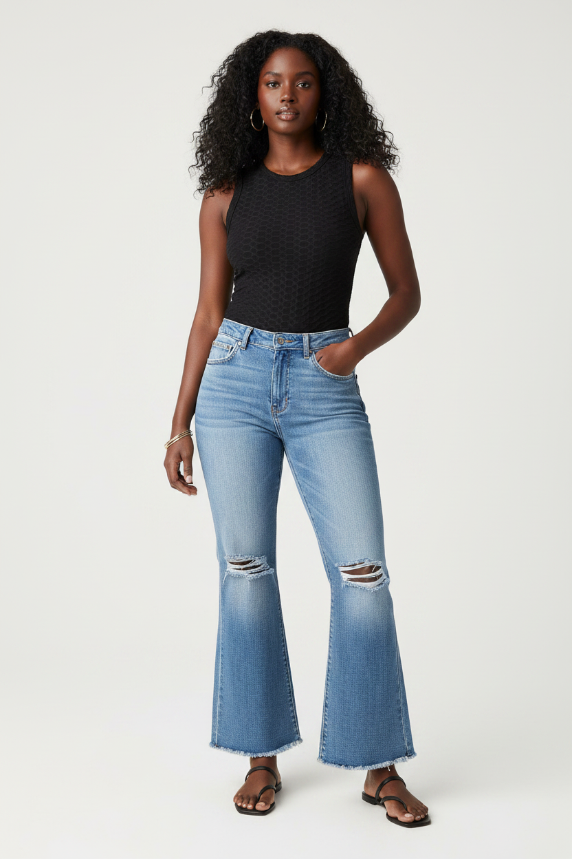 Black model wearing high-waisted distressed denim wide leg pants
